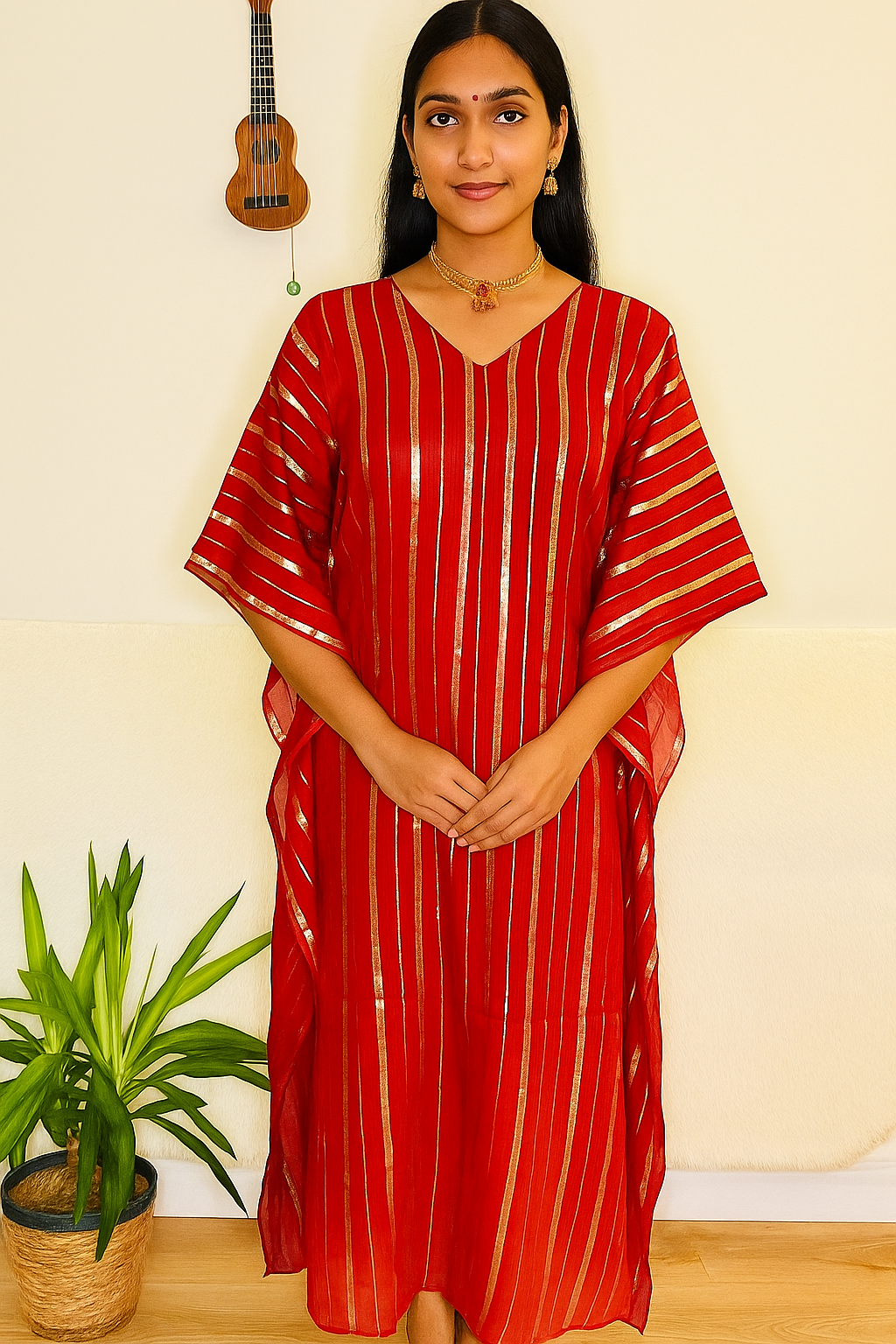 a flowing, red caftan (or kaftan) featuring vertical gold metallic stripes and a subtle V-neckline.
